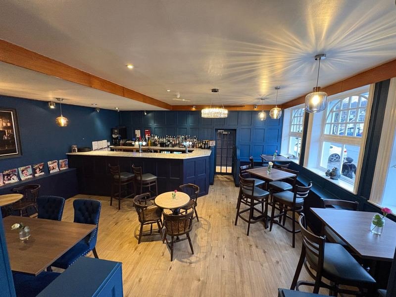 The bar, painted deep blue, with arched windows onto the High Street
