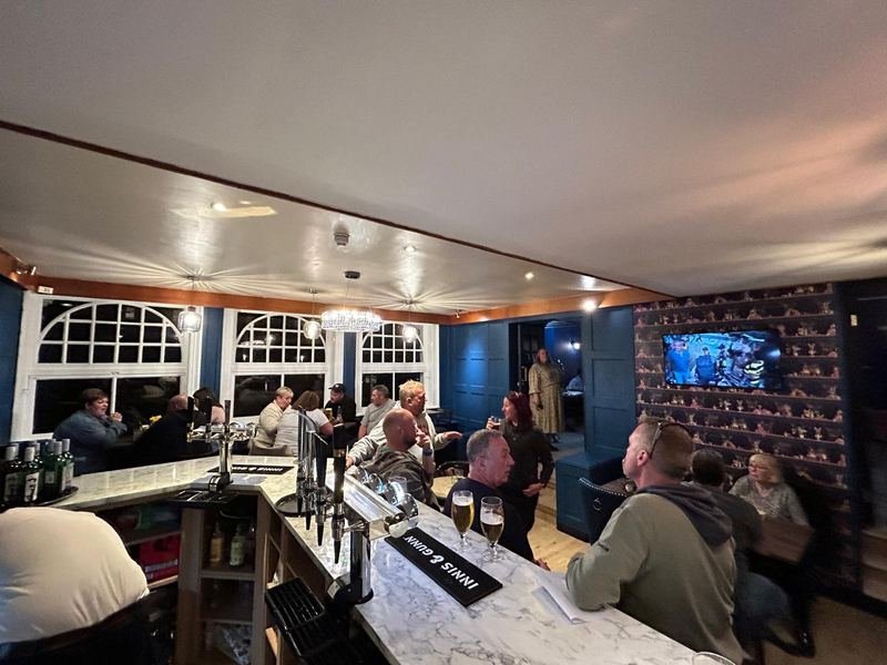 The bar on a busy evening, people at the counter