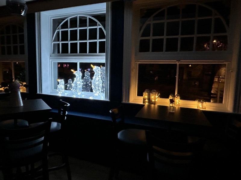 The bar windows at night, lit with candles