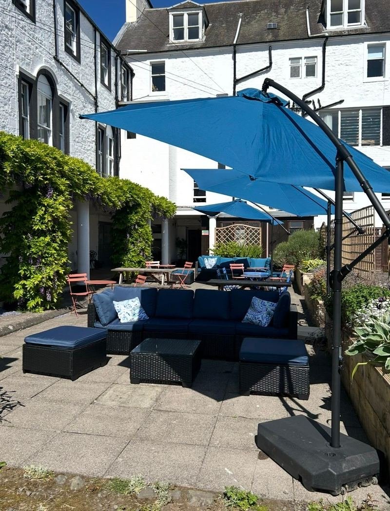 Blue sofas under parasols in the courtyard