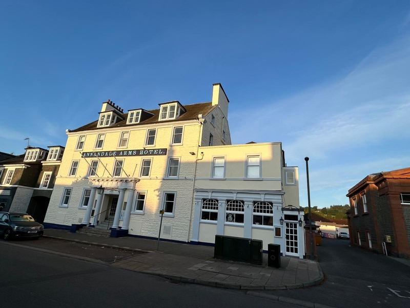 The front of the Annandale Arms on Moffat High Street, white Georgian frontage in evening sun